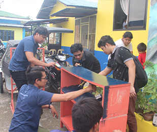 Employees Repainting School Equipments